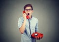 Shocked man receiving bad news on the phone Royalty Free Stock Photo