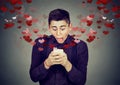 Shocked man receiving love sms text message on mobile phone Royalty Free Stock Photo