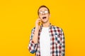 Shocked man talking on the phone, on a yellow background Royalty Free Stock Photo