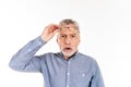 Shocked man taking off his glasses and looking camera with opened mouth isolated Royalty Free Stock Photo