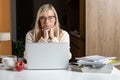 Shocked blonde middle aged woman feeling stressed reading unbelievable online news