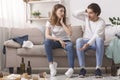 Shocked Millennial Couple Looking At Their Messy Flat After Party