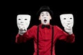 shocked mime holding two masks