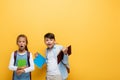 Shocked multiethnic schoolchildren holding books and