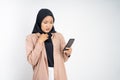 shocked muslim woman in hijab using a cell phone Royalty Free Stock Photo