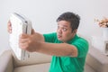 Shocked obese man while looking at a weight scale Royalty Free Stock Photo