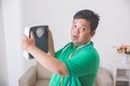 Shocked obese man while looking at a weight scale Royalty Free Stock Photo