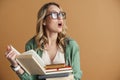 Shocked overloaded girl wearing glasses standing Royalty Free Stock Photo