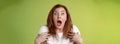 Shocked panicking redhead middle-aged woman gasping drop jaw open mouth stare camera freak-out anxious pointing herself