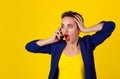 Shocked at phone Half length body woman short hair girl boy alike trans-gender talking on cell phone mobile looking stunned Royalty Free Stock Photo