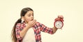 shocked punctual teen girl with alarm on background. photo of punctual teen girl with alarm clock.