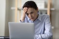 Shocked puzzled mature business lady reading bad news on Internet Royalty Free Stock Photo