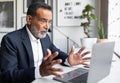 Shocked sad caucasian senior businessman in suit looks at computer in modern office interior Royalty Free Stock Photo