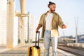 Shocked sad millennial caucasian man with suitcase looks on phone at train station Royalty Free Stock Photo