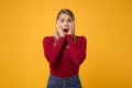 Shocked scared young blonde woman girl in casual clothes posing isolated on yellow orange background in studio. People Royalty Free Stock Photo