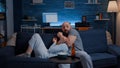 Shocked scared young couple eating popcorn watching horror movie on tv Royalty Free Stock Photo