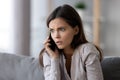 Shocked or scared young woman talking on mobile phone Royalty Free Stock Photo