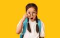 Shocked School Girl Looking At Camera Above Glasses, Studio Shot Royalty Free Stock Photo