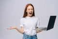 Shocked screaming young business woman or student with opened mouth holding keeping laptop computer Royalty Free Stock Photo