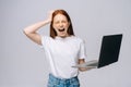 Shocked screaming young business woman or student with opened mouth holding keeping laptop computer Royalty Free Stock Photo