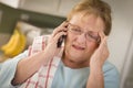 Shocked Senior Adult Woman on Cell Phone in Kitchen Royalty Free Stock Photo