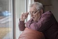Shocked senior man looking out of window Royalty Free Stock Photo