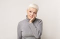 Shocked senior woman holding cheek up in total disbelief Royalty Free Stock Photo