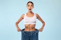 Shocked Skinny Woman Pulling Her Old Large Loose Jeans