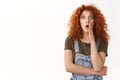 Shocked and speechless cute modern redhead curly-haired girl, gasping amazed, drop jaw fascinated and impressed, stare