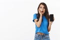 Shocked and startled, gasping young brunette female in blue t-shirt, gasping open mouth fascinated, react to something Royalty Free Stock Photo