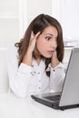 Shocked and stressed business woman at desk with her computer - Royalty Free Stock Photo