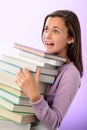 Shocked student girl carry stack of books