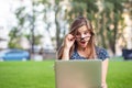 Shocked student with laptop computer looking at pc holding glasses down in shock Royalty Free Stock Photo