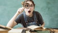 Shocked student looking through a magnifying glass Royalty Free Stock Photo