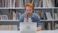 Shocked, Stunned Man with Red Hairs Working on Laptop Royalty Free Stock Photo