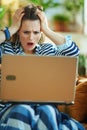 Shocked stylish woman with laptop at modern home in sunny day Royalty Free Stock Photo