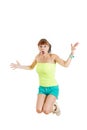 Shocked and surprised beautiful cute young woman or girl in blank green t-shirt and shorts jumps Royalty Free Stock Photo