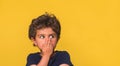 Shocked and surprised child boy looking away isolated on yellow background. concept for amazement, astonishment, making Royalty Free Stock Photo