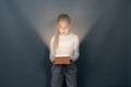 Shocked surprised child with glowing box. An interesting surprise. Gift Royalty Free Stock Photo