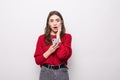 Shocked surprised girl looking at mobile phone with mouth open isolated over gray background Royalty Free Stock Photo