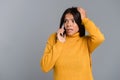 Shocked surprised woman posing isolated over grey wall background talking by mobile phone Royalty Free Stock Photo