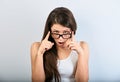 Shocked surprising woman in eyeglasses with open mouth looking on blue empty copy space background Royalty Free Stock Photo