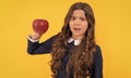 shocked teen girl with apple fruit. vitamin and dieting. child eating healthy food. childhood health Royalty Free Stock Photo