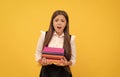 shocked teen girl hold books heap. too much work. back to school. education. book store. Royalty Free Stock Photo