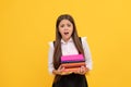 shocked teen girl hold books heap. too much work. back to school. education. book store. Royalty Free Stock Photo