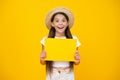 shocked teen girl hold empty advertisement paper with copy space on yellow background