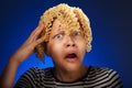 Shocked teen girl with macaroni instead hair