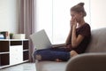 Shocked teenage girl with laptop in room Royalty Free Stock Photo
