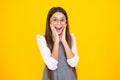 Shocked teenager child girl portrait  on yellow background. Excited face. Amazed expression, cheerful and glad. Royalty Free Stock Photo