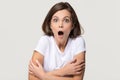 Shocked terrified young woman feeling afraid isolated on grey background